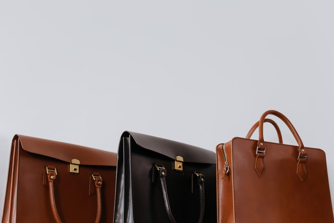A close-up view of three elegant leather briefcases emphasizing luxury and fashion.